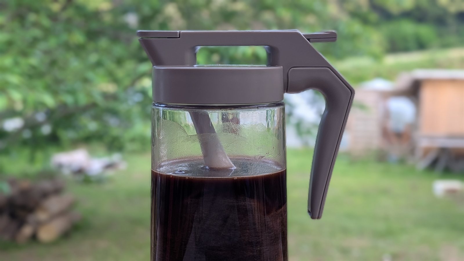 コーヒー粉を入れた不織布パックを、カトラリーなどの重しで容器内に水没させている様子